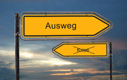 Zwei Wegweiser mit den Worten "Krise" und "Ausweg"